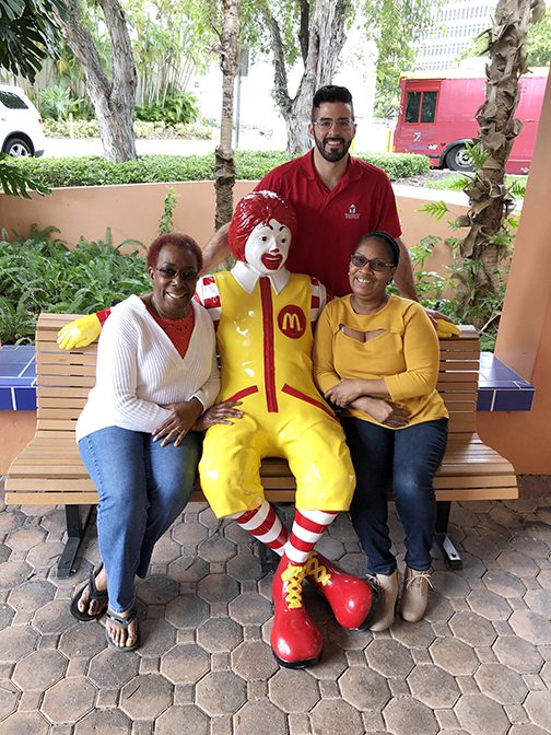A group of people posing with ronald mcdonald.