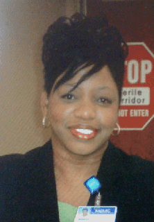 A woman with black hair and blue earrings.